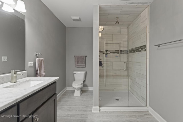 bathroom with vanity, hardwood / wood-style flooring, and a shower with shower door