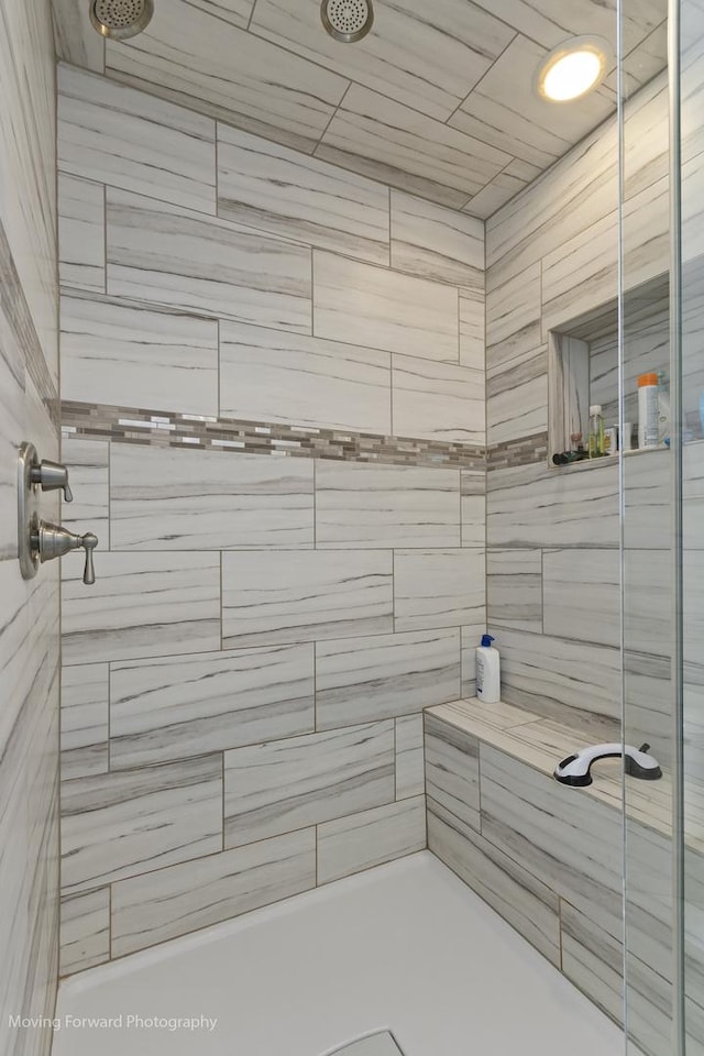 bathroom with a tile shower