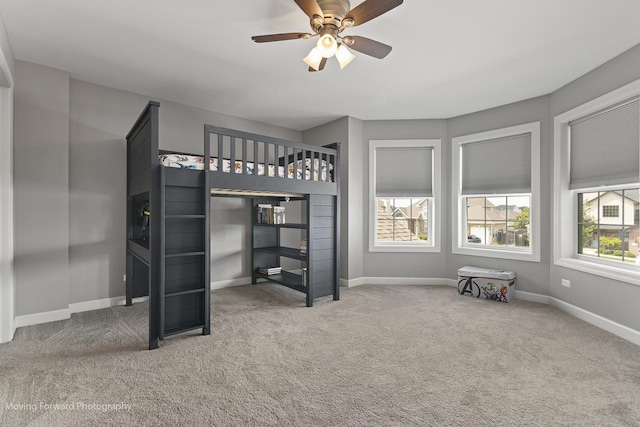 unfurnished bedroom featuring carpet floors and ceiling fan