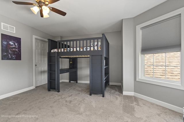 unfurnished bedroom featuring ceiling fan and carpet