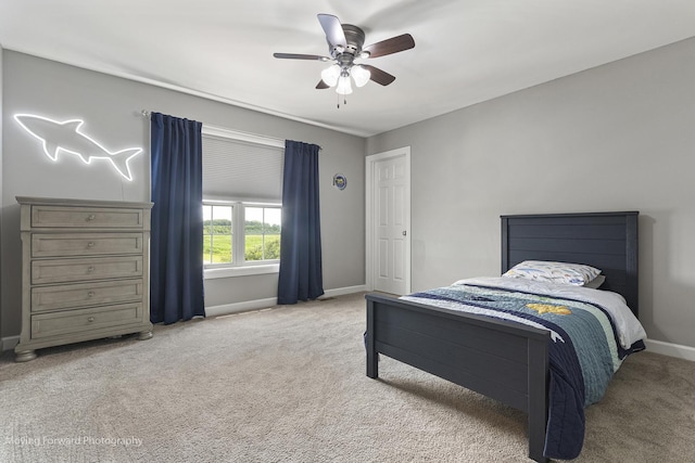 bedroom with ceiling fan and light carpet