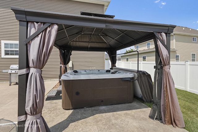 view of patio with a grill, a gazebo, and a hot tub