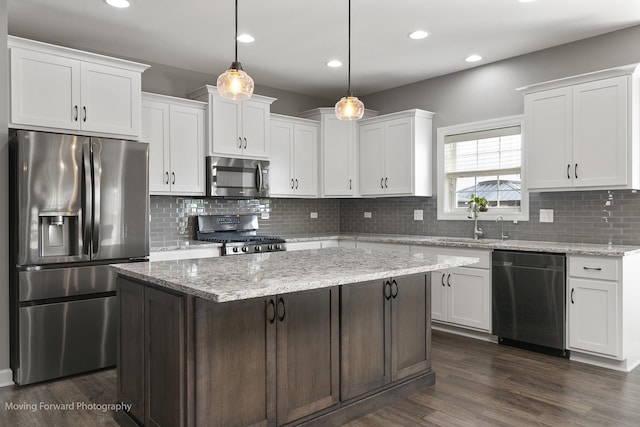 kitchen featuring appliances with stainless steel finishes, a center island, and white cabinets