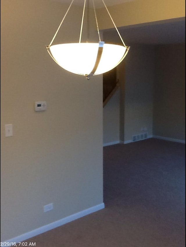 empty room featuring dark colored carpet