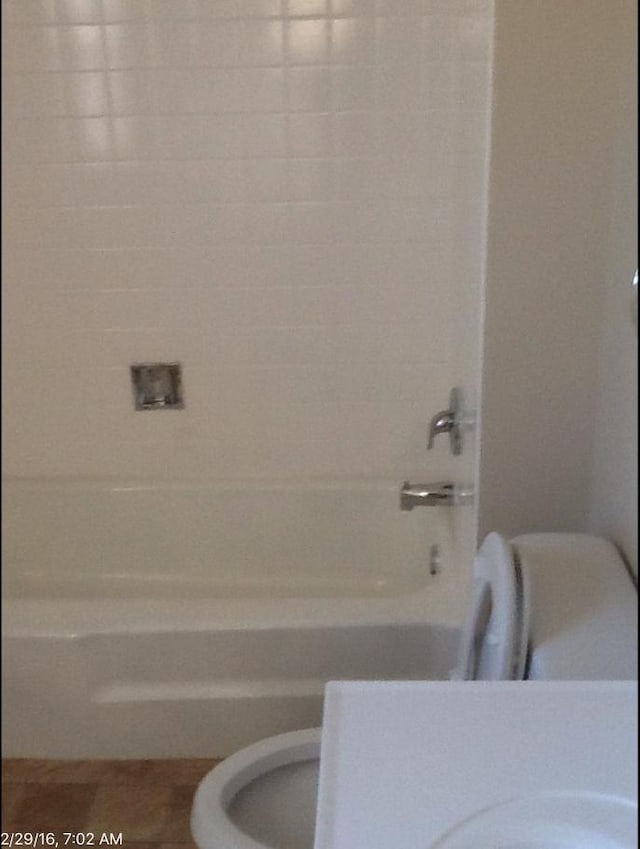 bathroom with shower / bath combination and toilet