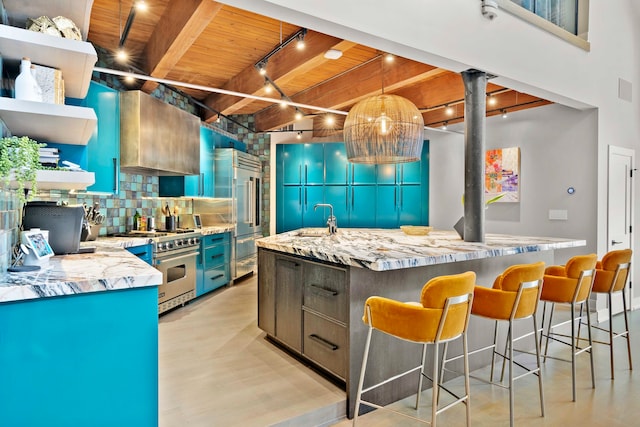 kitchen featuring sink, light stone counters, wooden ceiling, high quality appliances, and decorative backsplash