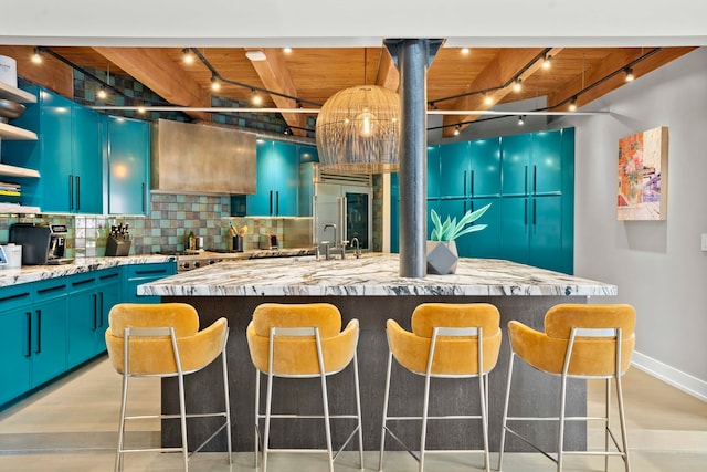 kitchen featuring rail lighting, backsplash, a center island, wood ceiling, and blue cabinetry