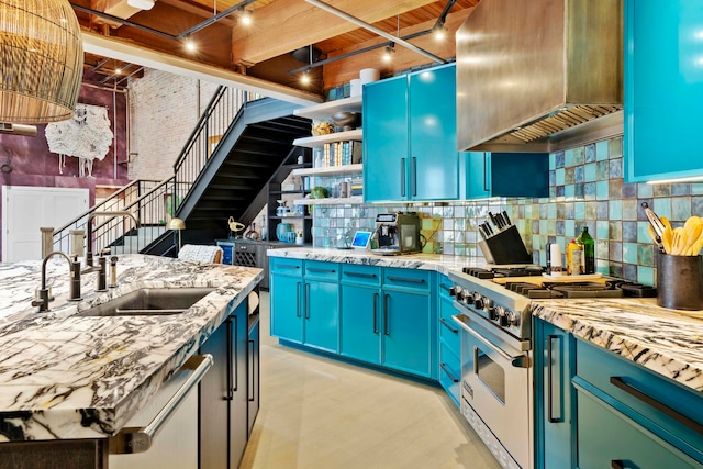 kitchen with tasteful backsplash, light stone counters, stainless steel range, ventilation hood, and blue cabinets