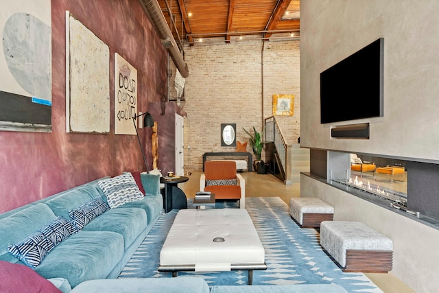 interior space featuring wood ceiling, brick wall, concrete floors, and a high ceiling