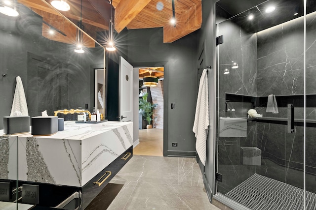 bathroom featuring beamed ceiling, vanity, and an enclosed shower