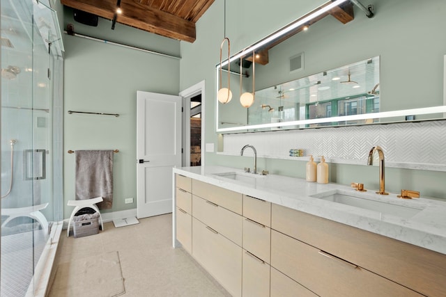 bathroom featuring backsplash, vanity, a shower with door, wooden ceiling, and beam ceiling