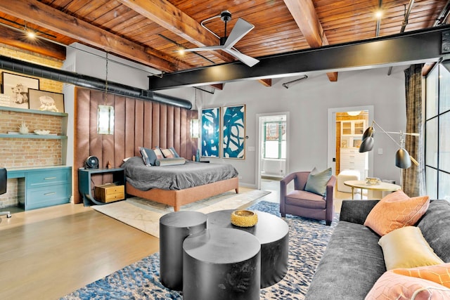 bedroom featuring wood-type flooring, beam ceiling, built in desk, and wooden ceiling