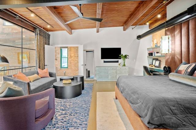 bedroom with beam ceiling, track lighting, light hardwood / wood-style floors, brick wall, and wooden ceiling