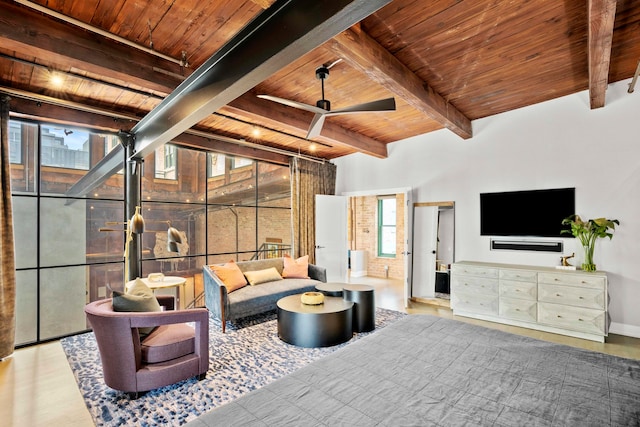 living room featuring beam ceiling, ceiling fan, light wood-type flooring, and wood ceiling