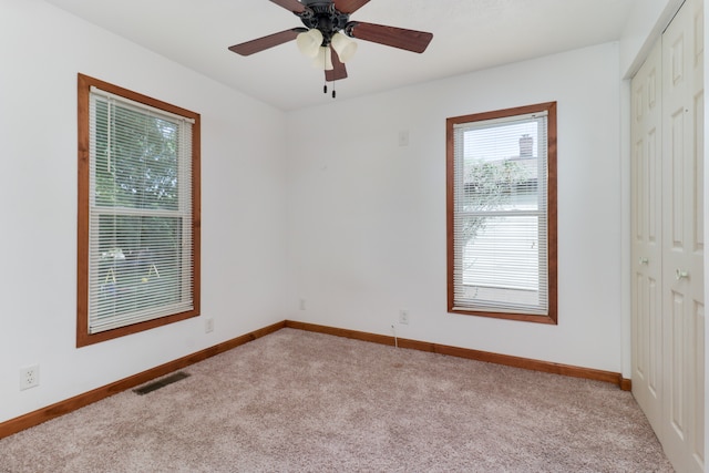 carpeted empty room with ceiling fan