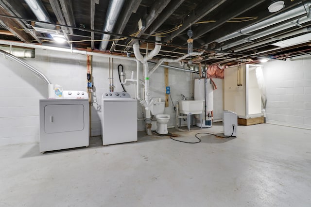 basement featuring independent washer and dryer and sink