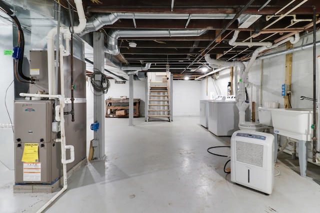 basement featuring washing machine and dryer and heating unit