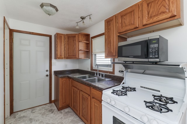 kitchen featuring white gas stove and sink