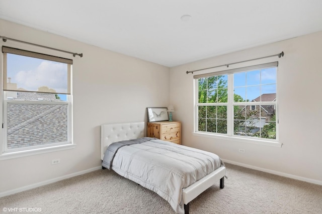 carpeted bedroom with baseboards