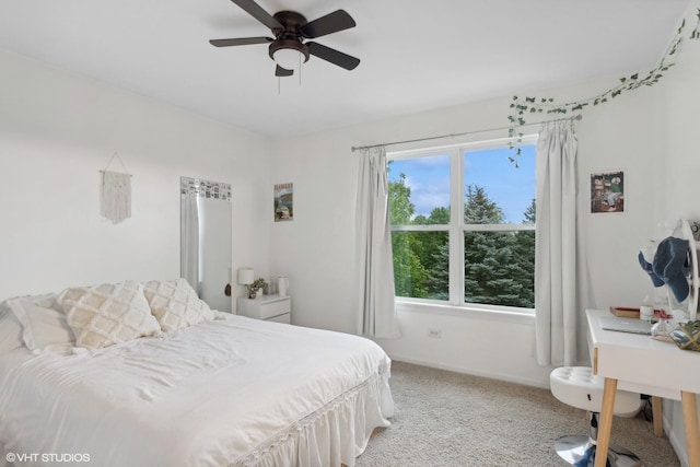 bedroom with light colored carpet, a ceiling fan, and baseboards