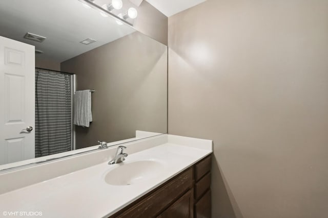 full bathroom with vanity and visible vents