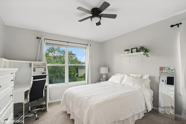 carpeted bedroom with a ceiling fan and baseboards