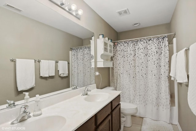 bathroom featuring a sink, visible vents, and toilet