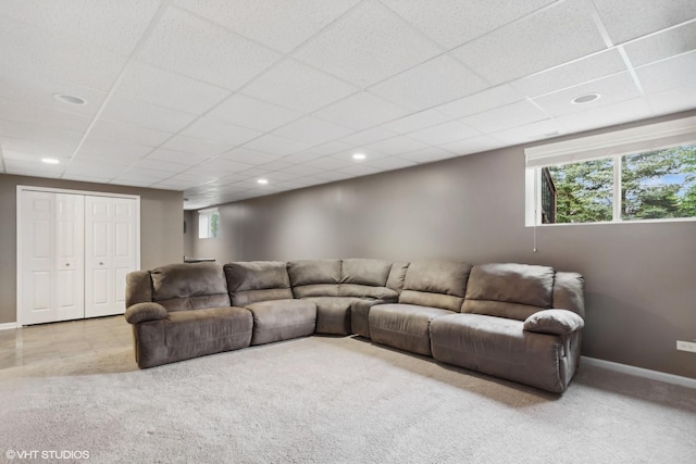 carpeted living room featuring recessed lighting, a paneled ceiling, and baseboards