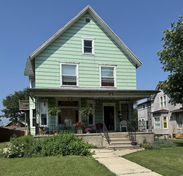 view of front of home featuring a porch and a front lawn