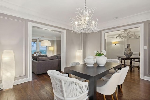 dining area featuring crown molding, dark wood-type flooring, and an inviting chandelier