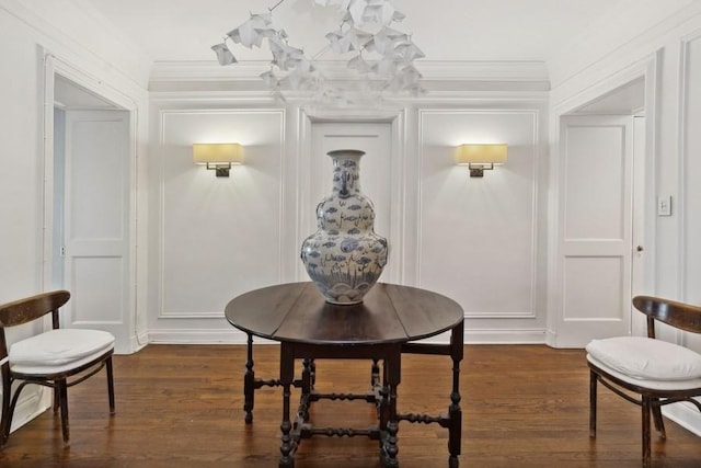 dining area featuring crown molding and dark wood-type flooring