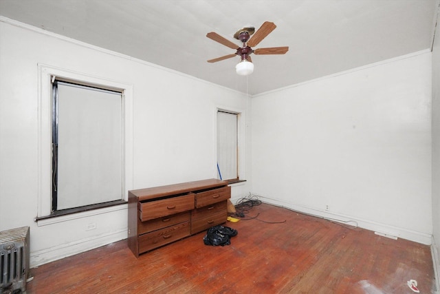 bedroom featuring radiator, ceiling fan, ornamental molding, and wood finished floors