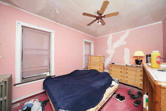 carpeted bedroom with ceiling fan, radiator heating unit, and crown molding