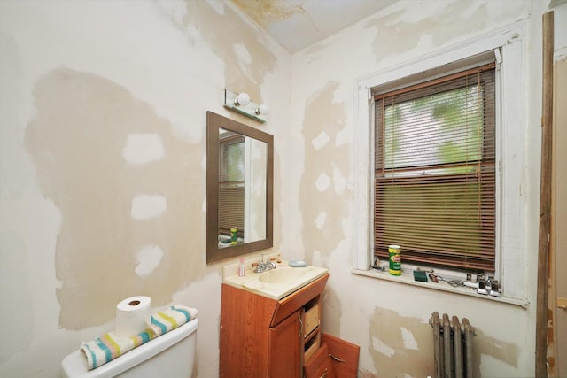 bathroom featuring radiator, vanity, and toilet