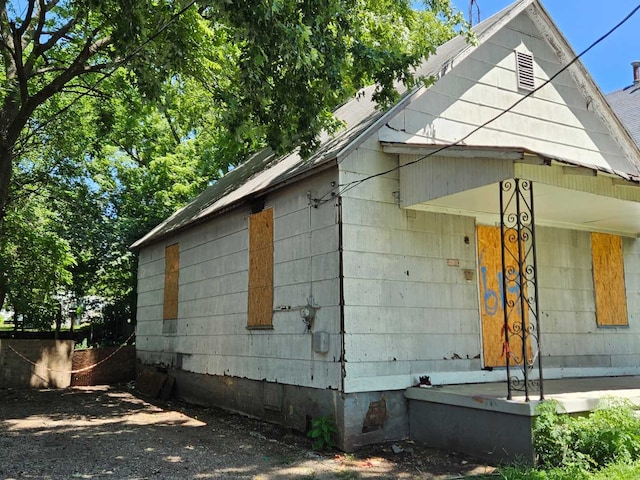 view of side of home featuring a porch