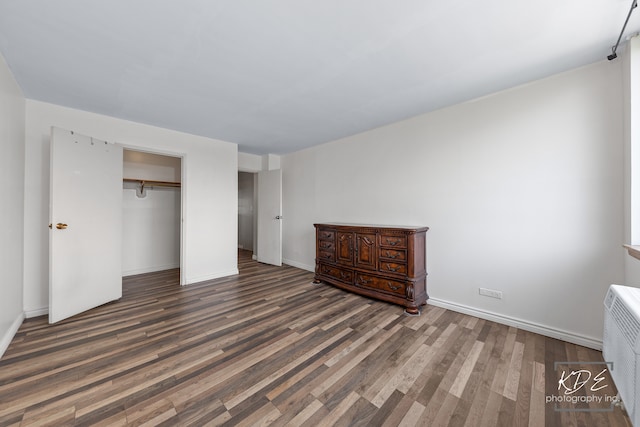 unfurnished bedroom featuring a closet and wood-type flooring