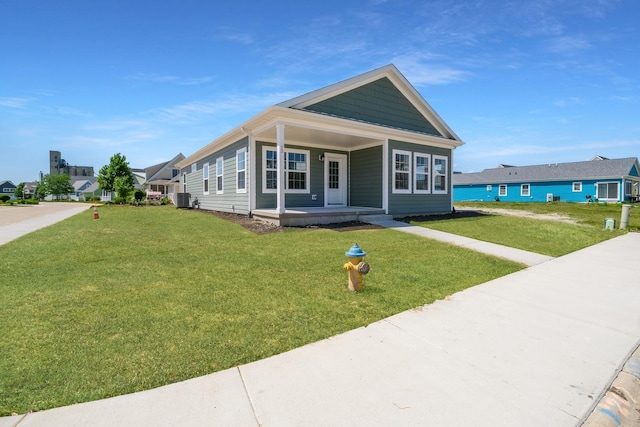 view of front of home with covered porch and a front yard