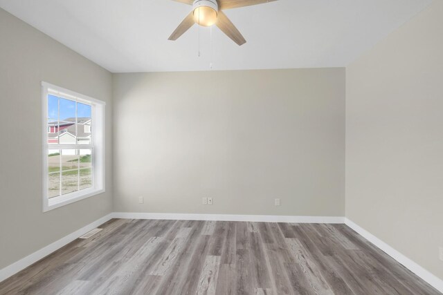 spare room with ceiling fan and light hardwood / wood-style floors