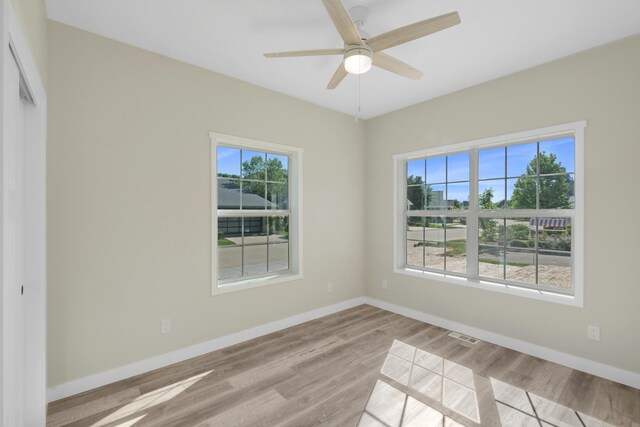 unfurnished room with ceiling fan and light wood-type flooring