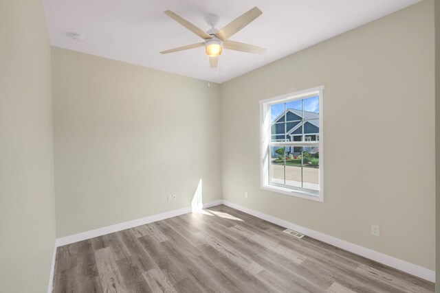 empty room featuring ceiling fan and light hardwood / wood-style floors