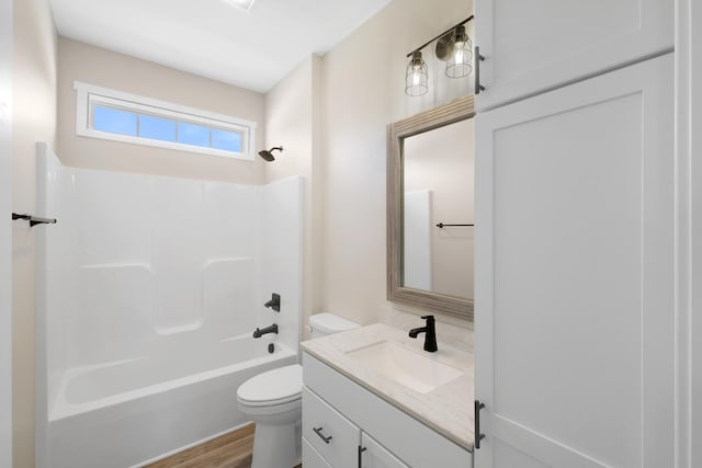 full bathroom featuring vanity, toilet,  shower combination, and hardwood / wood-style floors