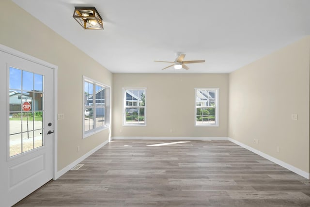 13 Starboard St, Ottawa, IL 61350 - unfurnished room featuring ceiling fan, a healthy amount of sunlight, and light wood-type flooring