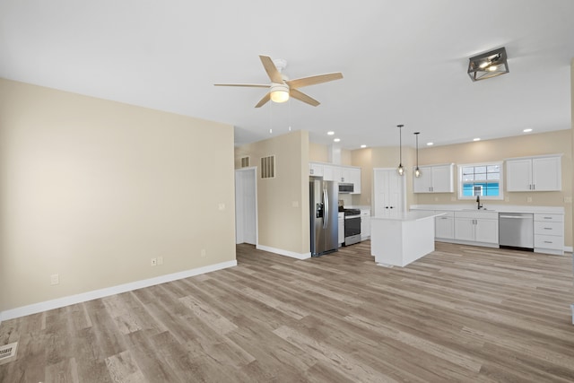 kitchen featuring white cabinets, stainless steel appliances, ceiling fan, and light hardwood / wood-style floors