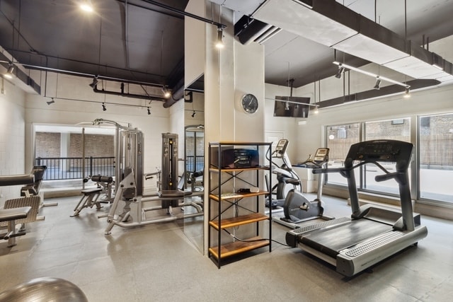 gym with a towering ceiling