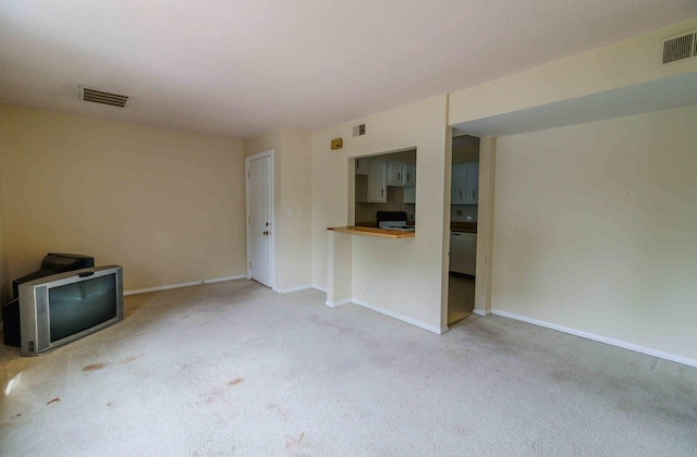 unfurnished living room with light carpet