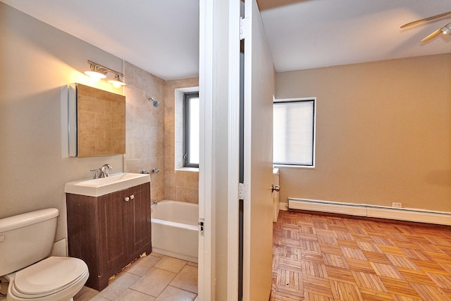 full bathroom featuring toilet, parquet floors, a baseboard radiator, vanity, and tiled shower / bath combo