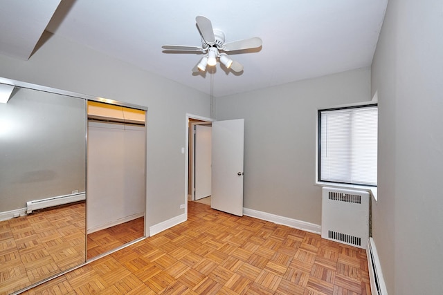 unfurnished bedroom featuring ceiling fan, a baseboard radiator, a closet, and light parquet floors