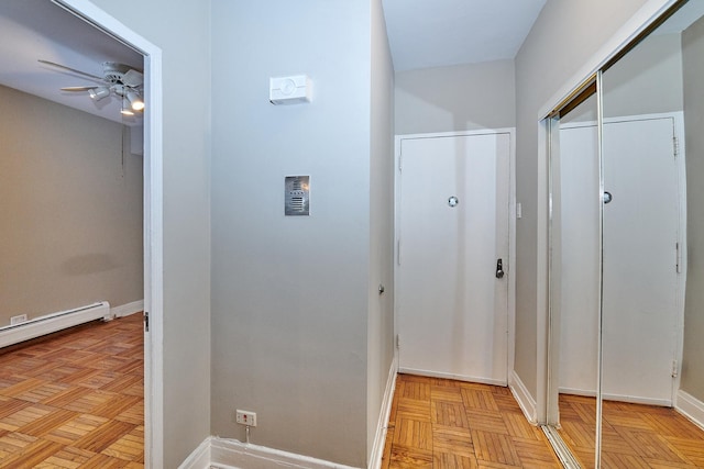 hallway featuring light parquet flooring and a baseboard heating unit