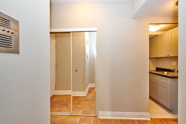 bathroom with parquet floors and sink