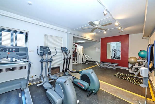 gym with ceiling fan and track lighting